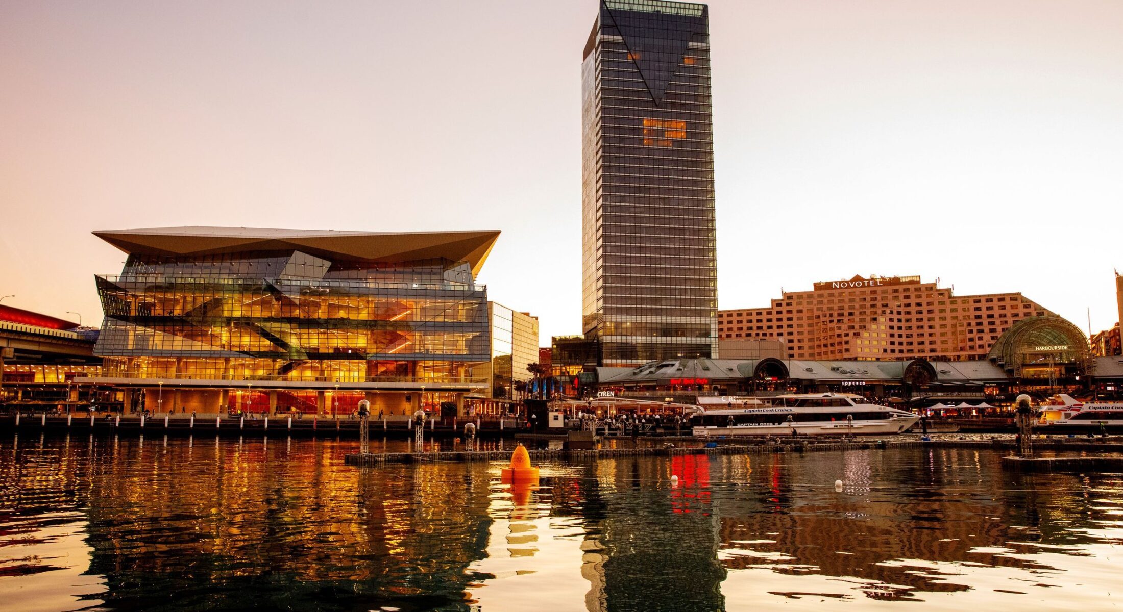 Sun setting over the International Convention Centre (ICC) and Sofitel Sydney Darling Harbour hotel.